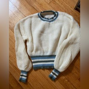 off white sweater with stripped blue and green detail